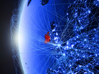 Ireland from space on blue digital model of Earth with international network. Concept of blue digital communication or travel.