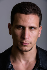 Obraz premium Face of young muscular Persian man thinking while looking at dis