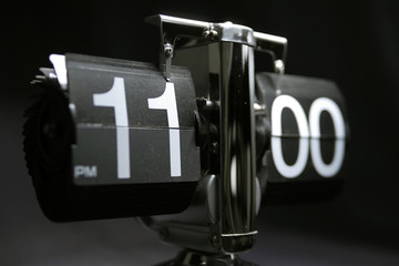 Classic flip clock watch face showing hour and minutes set to 11:00 PM	