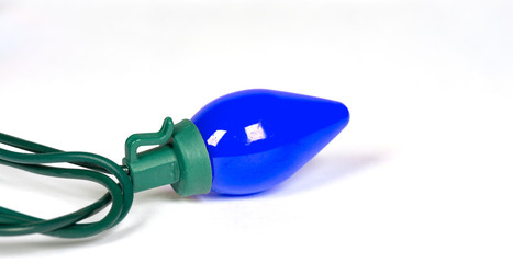 Blue retro led bulb light isolated on white with a shallow depth of field