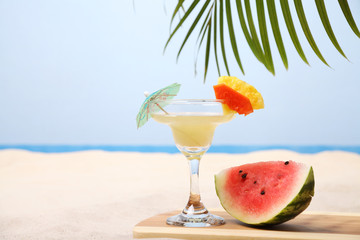 Tropical drink on white sand at the beach