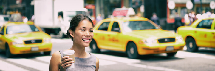 New York city commute - Asian business woman walking to work in the morning commuting drinking...