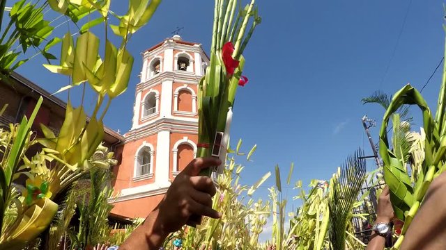 San Pablo City, Laguna, Philippines, March 25, 2018: Church tower background, Catholics celebrate Palm Sunday before Easter. The feast commemorates Jesus' triumphal entry into Jerusalem,