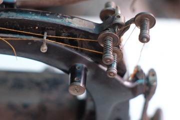 Close-up part of an old sewing machine and detail on adjust  thread tension regulater