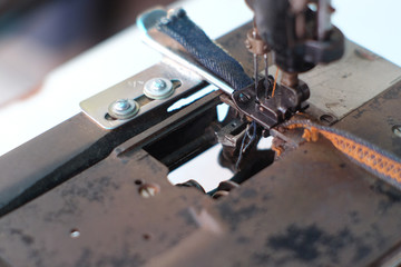 Closeup part of an old sewing machine and detail on needle & thread,presser foot