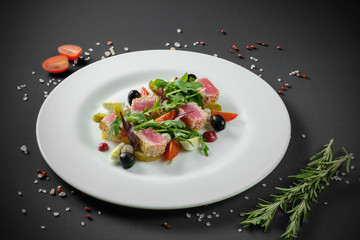 Salad with ham on white plate