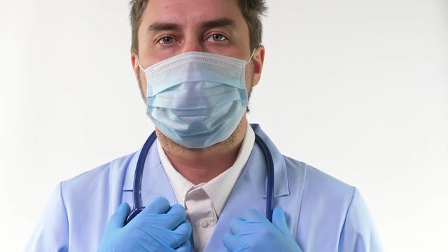 Young doctor in mask stand and doing thumbs up