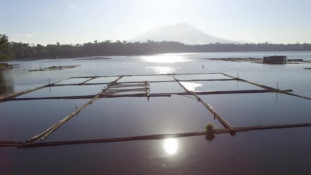 Bamboo hut Temporary structure for local aquaculture provide domestic food needs of small rural farming community in Sampaloc Lake, Laguna. drone, aerial shot