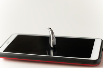Hearing aid and earphone. The concept of hearing care.