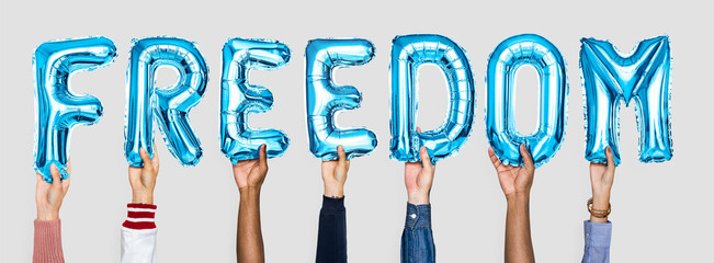 Blue alphabet balloons forming the word freedom