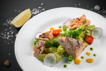 Fried salmon on white plate