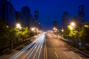 Fototapeta premium Light trails on the street at Beijing Central Business district at night in Beijing ,China.