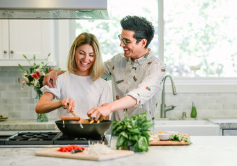 Happy couple cooking in the kitchen