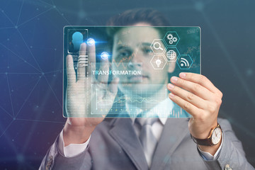 The concept of business, technology, the Internet and the network. A young entrepreneur working on a virtual screen of the future and sees the inscription:Transformation