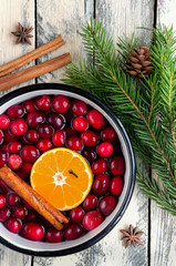 Christmas potpourri. Top view. Hot scented beverage made from cranberry, cinnamon, clementines and...