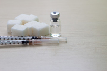 Treatment of diabetes. Syringe, ampoule and sugar