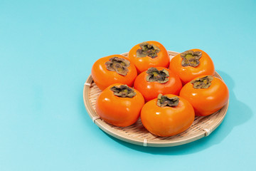 Persimmons on the blue background