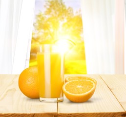 Orange juice and slices of orange on background