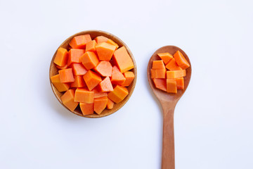 ripe cut papaya on wooden bowl and spoon on white background