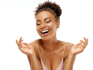 Young girl with perfect skin. Photo of african american girl laughing on white background. Youth and Beauty