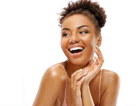 Laughing girl with flawless skin. Photo of african american girl on white background. Youth and skin care concept