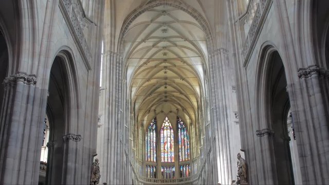 vertical panorama inside view of catholic cathedral with columns, statues of pope