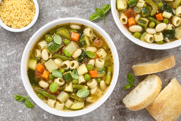 Vegetable soup made of zucchini, celery, carrot, peas, white beans, green beans, potato, tomato,...