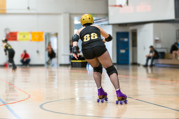 Roller derby players compete against each other