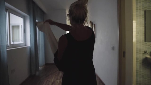 Close up, woman walks in house