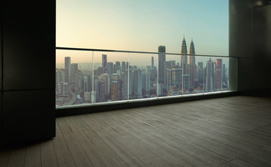 Black wall and wood floor balcony with Kuala Lumpur city background .