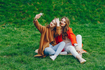 The girls are walking in the park.