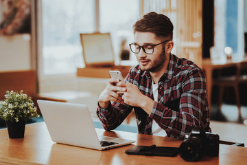 Freelancer Uses Phone and Work on Laptop Remotely