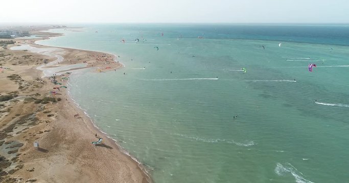 Aerial, tons of parasailors off beach