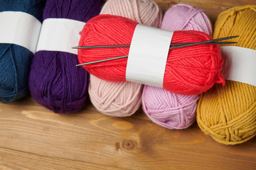 colorful wool yarn for knitting on wooden background