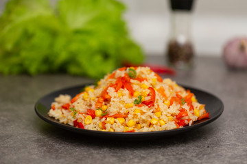 Chinese fried rice with vegetables, served on a plate with chopsticks. Selective focus