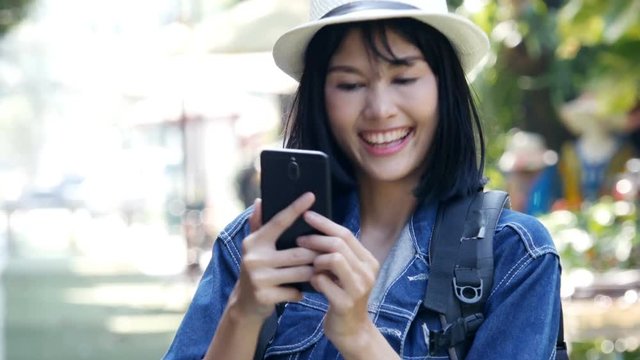 Attractive female using smartphone while travel. People with travel, lifestyle, holiday concept.