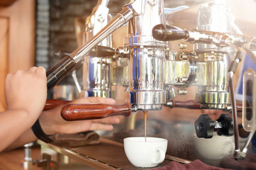 close up of coffee machine preparing cup of coffee