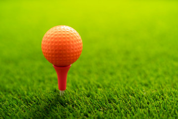 Golf ball on green grass with copy space