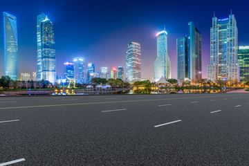 Empty asphalt road along modern commercial buildings in China's cities
