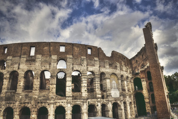 Fototapeta premium Mad clouds and Colisseum old building in Rome city, Italy