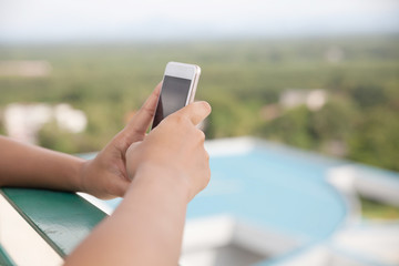 Hand of woman using smartphone. 