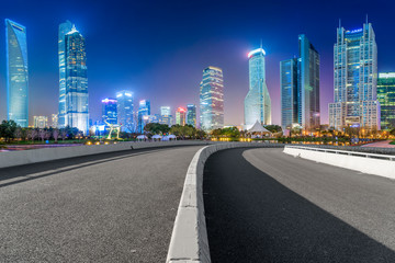 Fototapeta na wymiar Empty asphalt road along modern commercial buildings in China's cities