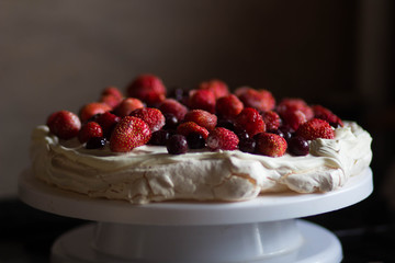 Dessert Anna Pavlova  topped with strawberry and cherry