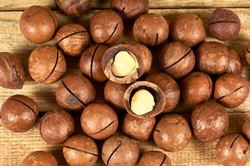 Macadamia nuts on wooden table, flat lay