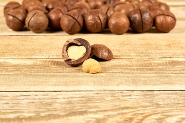 Macadamia nuts on wooden table with copy space, flat lay