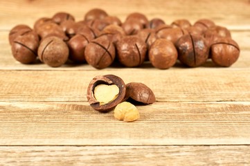 Macadamia nuts on wooden table with copy space, flat lay
