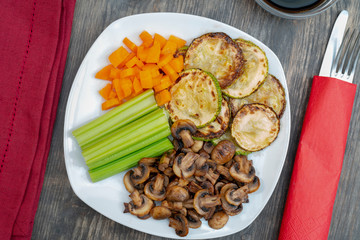 Vegan diet food. Fried mushrooms with celery, carrots and zucchini.