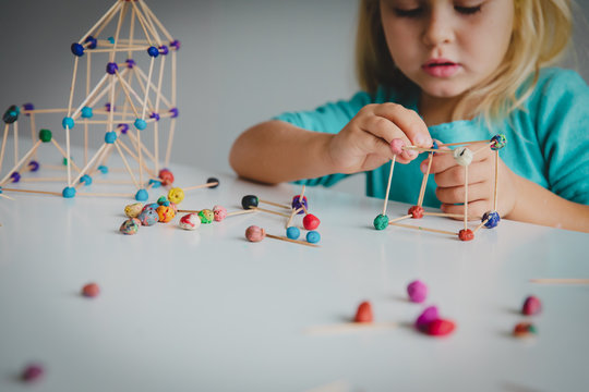 little girl making geometric shapes, engineering and STEM