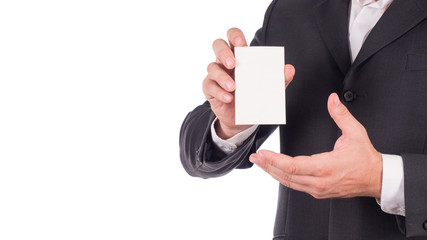 Businessman in a black suit holding a card over white background