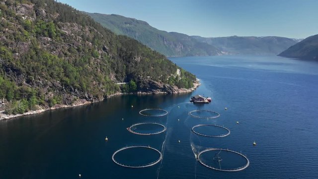 Aerial shot of a fish farm in Norway. 4K, UHD